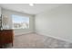 Bright bedroom with a large window, plush carpet, and neutral paint scheme at 4321 Hornyak Dr, Monroe, NC 28110