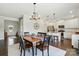 Bright dining area with modern chandelier, and an open view to the kitchen at 4321 Hornyak Dr, Monroe, NC 28110