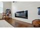 A sleek, modern fireplace framed by shiplap and hardwood floors at 4321 Hornyak Dr, Monroe, NC 28110