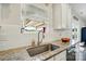 Close-up of a kitchen sink and granite countertops with white cabinets and stainless steel appliances at 4321 Hornyak Dr, Monroe, NC 28110