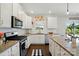 Bright kitchen features white cabinets, granite countertops, and stainless steel appliances at 4321 Hornyak Dr, Monroe, NC 28110