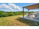 Outdoor living space with pergola, seating, and landscaped backyard view at 4321 Hornyak Dr, Monroe, NC 28110