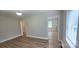 Open-concept living room with vinyl floors, neutral walls, and ample natural light at 440 27Th Street Sw Pl, Hickory, NC 28602