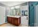 This is a bathroom with a double vanity and doorway view to another room at 4506 S Potter Rd, Monroe, NC 28112