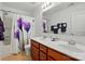 Bathroom featuring double vanity, toilet, shower with purple floral curtain at 4506 S Potter Rd, Monroe, NC 28112
