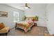 A bedroom with white walls and a colorful bed at 4506 S Potter Rd, Monroe, NC 28112
