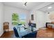 Bright dining area featuring a modern glass table, blue chairs and large windows offering scenic views at 4506 S Potter Rd, Monroe, NC 28112