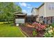 Home exterior with screened patio, garden, and landscaped yard with mature trees and flowering bushes at 4506 S Potter Rd, Monroe, NC 28112