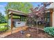 Home exterior featuring a screened-in patio with a hot tub and scenic landscaping at 4506 S Potter Rd, Monroe, NC 28112