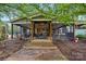 Home exterior featuring a screened-in patio with seamless integration with the natural outdoor landscape at 4506 S Potter Rd, Monroe, NC 28112