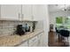 Granite countertops with a white subway tile backsplash, complemented by ample cabinet space in the kitchen at 4506 S Potter Rd, Monroe, NC 28112