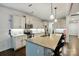 Modern kitchen showcasing a spacious island with bar stools and stainless steel appliances, perfect for entertaining at 4506 S Potter Rd, Monroe, NC 28112