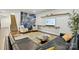 Stylish living area with a comfortable leather sofa, floating shelves, and large windows for natural light at 4506 S Potter Rd, Monroe, NC 28112