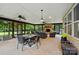 Expansive screened-in patio featuring brick fireplace, ceiling fans, dining area, and outdoor seating for entertainment at 4506 S Potter Rd, Monroe, NC 28112