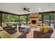 Relaxing screened-in patio with brick fireplace and comfortable wicker seating for enjoying the outdoor scenery at 4506 S Potter Rd, Monroe, NC 28112