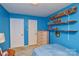 This bedroom features blue walls, shelving, and natural light from the window at 4810 Shea Ct, Monroe, NC 28110