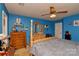 Cozy bedroom with a four-poster bed, dressers, ceiling fan, and calming blue walls at 4810 Shea Ct, Monroe, NC 28110