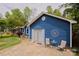 Exterior shot of the blue home displaying front lawn, driveway, and a cozy patio area with seating at 4810 Shea Ct, Monroe, NC 28110