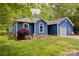 Blue single-story home with a well-manicured lawn, landscaping, and a welcoming facade at 4810 Shea Ct, Monroe, NC 28110