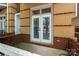 Back porch overlooking trees with an exterior brick and white door at 510 N Alexander St, Charlotte, NC 28202