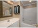 Well-lit bathroom features a vanity with mirror, cabinet and a shower-tub combination at 510 N Alexander St, Charlotte, NC 28202