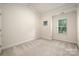 Neutral bedroom with natural light from two windows overlooking green space at 510 N Alexander St, Charlotte, NC 28202