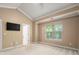 Bedroom featuring high ceilings, a large window, and neutral carpet at 510 N Alexander St, Charlotte, NC 28202