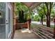 Front porch featuring a door, green trees and neutral color siding at 510 N Alexander St, Charlotte, NC 28202