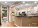 Bright kitchen with hardwood floors, stainless steel appliances, and white cabinets at 510 N Alexander St, Charlotte, NC 28202