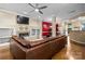 Inviting living room with hardwood floors, fireplace, and large leather sectional sofa at 510 N Alexander St, Charlotte, NC 28202