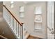 Bright staircase with neutral carpet, wooden handrail, and natural light from windows at 510 N Alexander St, Charlotte, NC 28202