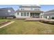 A well-maintained backyard, featuring a wooden deck, lounge furniture, a hot tub, and a garden at 528 Rock Skip Way, Fort Mill, SC 29708