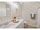 Stylish bathroom featuring double sink vanity, decorative mirrors, and unique wallpaper design at 528 Rock Skip Way, Fort Mill, SC 29708
