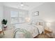 Comfortable bedroom with neutral colors, large windows, and ceiling fan at 528 Rock Skip Way, Fort Mill, SC 29708
