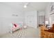 Bedroom featuring a crib, modern ceiling fan, plush rug, and natural light at 528 Rock Skip Way, Fort Mill, SC 29708