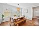 Inviting dining room with a wooden table, bench seating, and a view of the backyard at 528 Rock Skip Way, Fort Mill, SC 29708