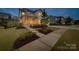 A well-lit home with a walkway leading to the front entrance, complimented by landscaping at 528 Rock Skip Way, Fort Mill, SC 29708