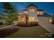 A charming home with a manicured front yard, showcasing the architecture and curb appeal at twilight at 528 Rock Skip Way, Fort Mill, SC 29708