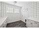 This laundry room has gray and white wall paper, a white counter top, and dark floors at 528 Rock Skip Way, Fort Mill, SC 29708