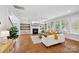 Inviting living room with a fireplace, built-in shelving, and hardwood floors at 528 Rock Skip Way, Fort Mill, SC 29708