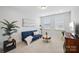 Comfortable living room space with cozy blue couch, carpeted floors and natural light at 528 Rock Skip Way, Fort Mill, SC 29708