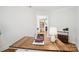 Cozy home office space with rustic desk and view of fireplace in adjacent room at 528 Rock Skip Way, Fort Mill, SC 29708