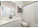 Modern bathroom features a sleek vanity, matte black fixtures, and a shower with a curtain at 6070 Trinity Crossing Cir, Kannapolis, NC 28081