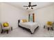 Cozy bedroom with a plush bed, patterned chairs, and soft natural light streaming through the window at 6070 Trinity Crossing Cir, Kannapolis, NC 28081