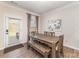 Dining room features a wooden table with bench seating and access to the outdoor living space at 6070 Trinity Crossing Cir, Kannapolis, NC 28081