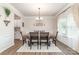 Dining area featuring hardwood floors, chandelier, and decorative wainscoting at 6070 Trinity Crossing Cir, Kannapolis, NC 28081