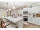 Beautiful kitchen boasts a large island, modern appliances, white cabinetry, and stylish pendant lighting at 6070 Trinity Crossing Cir, Kannapolis, NC 28081