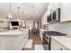 Open-concept kitchen with island, stainless steel appliances, and seamless flow into living space at 6070 Trinity Crossing Cir, Kannapolis, NC 28081