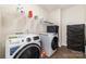 Functional laundry room with washer, dryer, and shelving for ample storage at 6070 Trinity Crossing Cir, Kannapolis, NC 28081