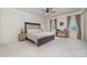Spacious main bedroom with neutral tones, a ceiling fan, and ample natural light from large windows at 6070 Trinity Crossing Cir, Kannapolis, NC 28081